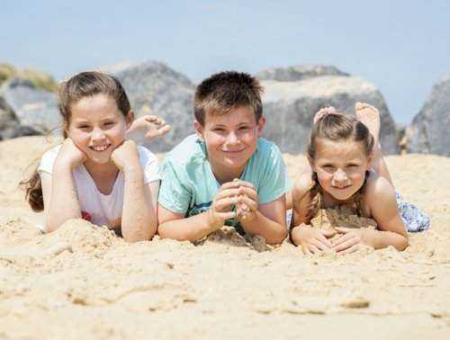Children posing for a photograph at the Beach