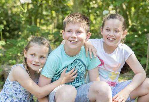 Children smiling during outdoor photography session
